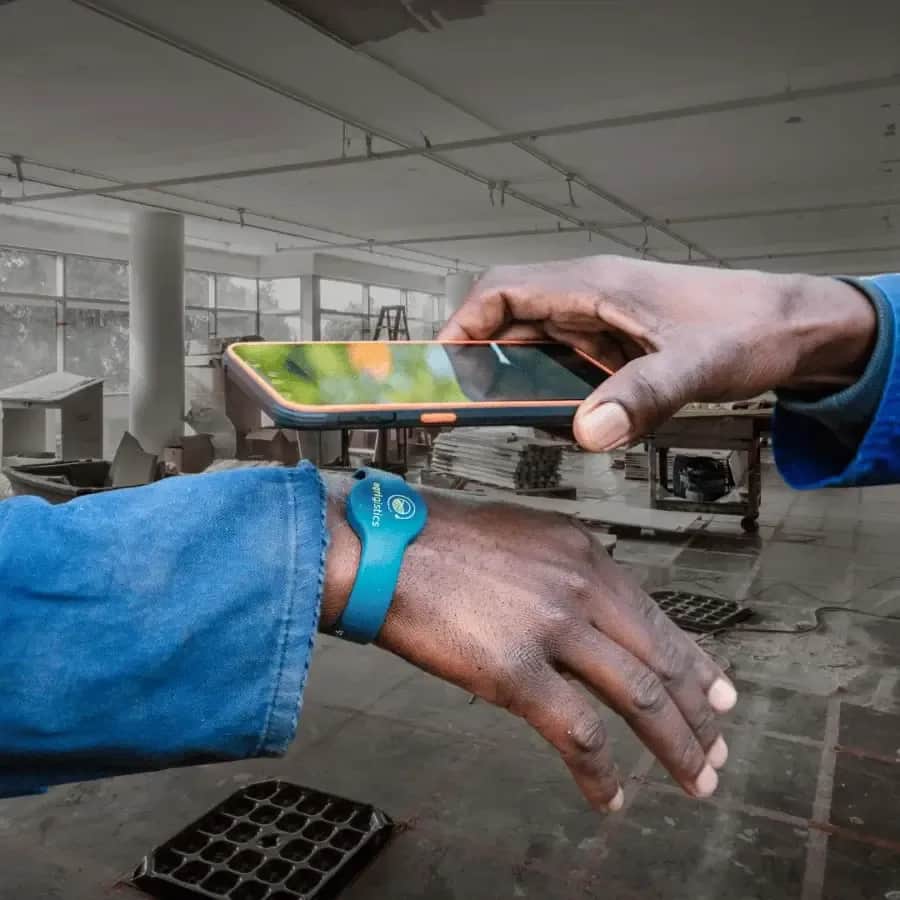 Construction worker clocking in with an RFID wristband using a handheld device